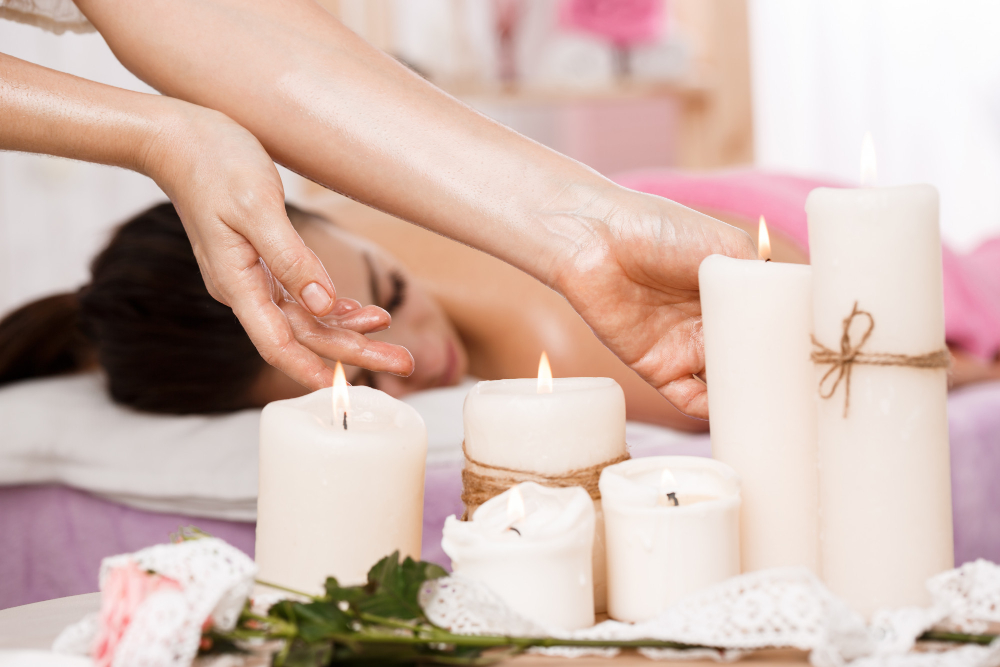 closeup photo female hands taking candles spa salon